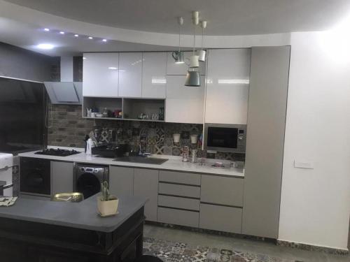 a kitchen with white cabinets and a stove top oven at Stunning Vacation Rental in Matn Lebanon in Dbayeh