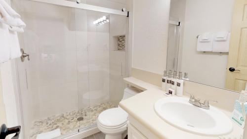 a bathroom with a toilet and a sink and a shower at Tamarack Townhomes - CoralTree Residence Collection in Snowmass Village