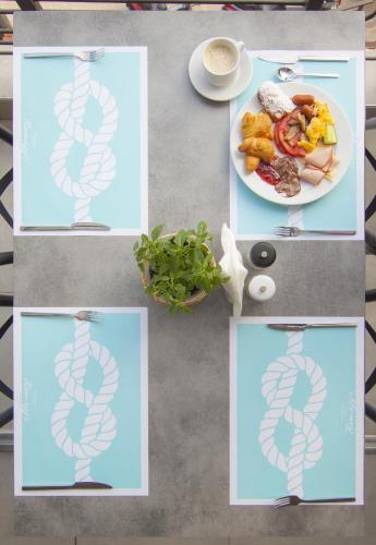 a table with a plate of food with a drawing of a neurologicaletheusetheusetheus at Ntinas Filoxenia Hotel & Spa in Skala Potamias