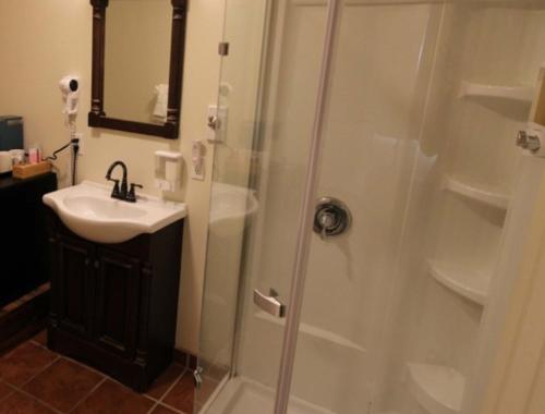 a bathroom with a shower and a sink at Back Bay Inn in San Luis Obispo