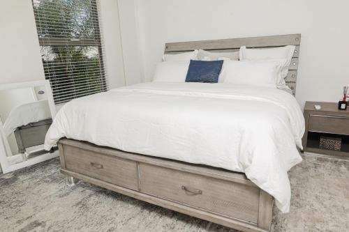 a bedroom with a large bed and a window at Bella Studio Apartments - Lux Loft in Kingston