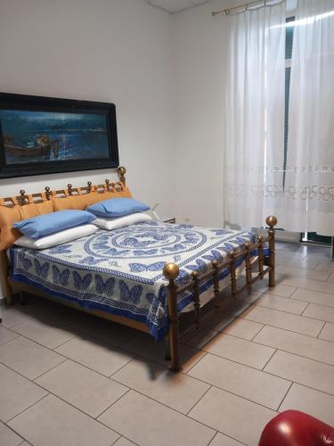 a bedroom with a bed with blue pillows on it at Casa Surunova in Naples