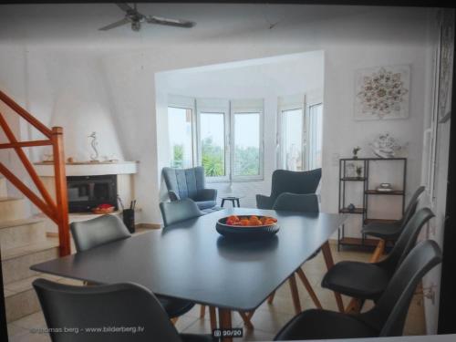a living room with a table and chairs at Tapia Hills in Methoni