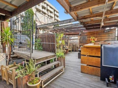 a deck with a bench and plants on it at Edouard Boat in Brussels