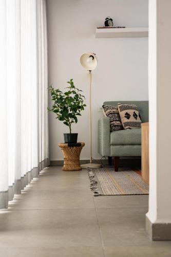 a living room with a couch and a plant at Family Apartment By IsrApart in Ramat Gan