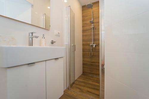 a bathroom with a sink and a shower at Old Town Apartments in Korčula