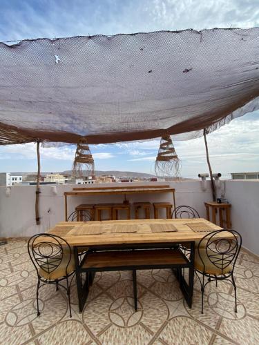 a table and chairs sitting on top of a roof at Atlas Surf Morocco in Tamraght Ouzdar