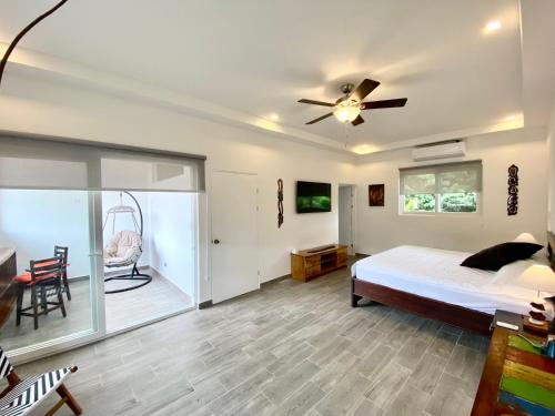 a bedroom with a bed and a ceiling fan at Jacarandas #16, 5 min tamarindo in Villarreal