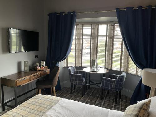 a bedroom with a bed and a table and chairs at The Ivy Tree in Stockton-on-Tees