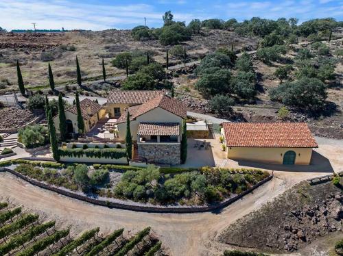 an aerial view of a house with a vineyard at Tuscan Villa w/Vineyard Views! in Murrieta