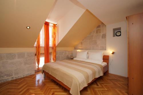 a bedroom with a large bed in a attic at Old Town Apartments in Korčula