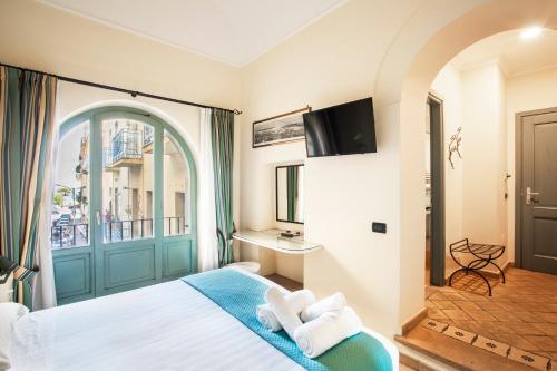 a hotel room with a bed and a window at Il Quartuccio Gaeta in Gaeta