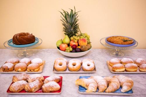 a table topped with different types of pastries and pies at Quartuccio - Albergo Diffuso - Gaeta in Gaeta