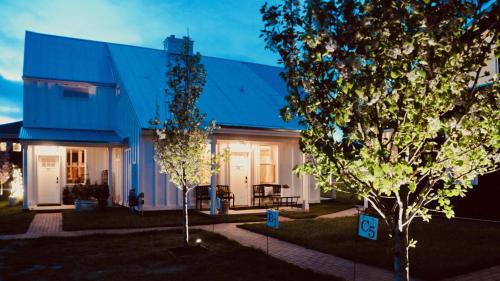 a house with a blue roof and two trees at Inn Santa Clara in Santa Clara