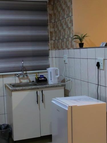 a kitchen with a sink and a counter top at Makobaneng Guesthouse in Ga-Raphokola