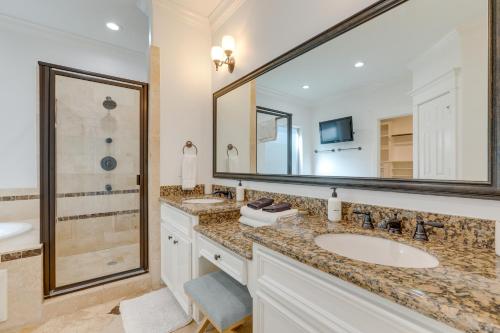 a bathroom with two sinks and a large mirror at Houston Home Near Downtown with Pool and Hot Tub! in Houston