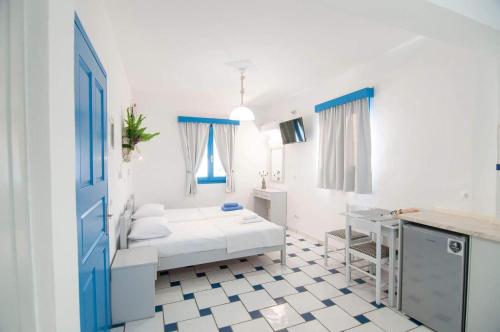 a white room with a bed and a sink at GIAVASI SEASIDE FINIKI in Foinikion