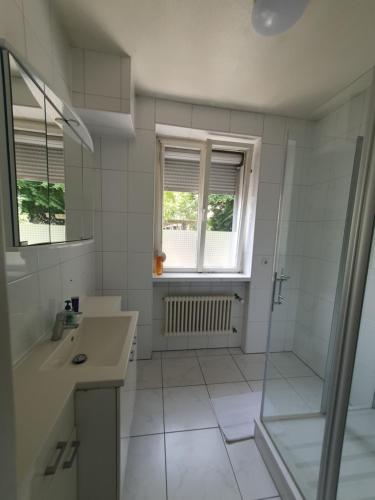 a white bathroom with a shower and a sink at Privatzimmer an der Uniklinik Mainz, sehr zentral in Mainz