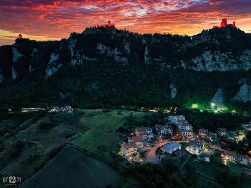 uma vista aérea de um resort nas montanhas ao pôr-do-sol em One Suite em San Marino