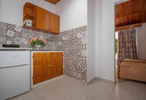 a kitchen with a white refrigerator and a counter at Dora Studios Best Location In Laganas Next To The Party Area in Laganas
