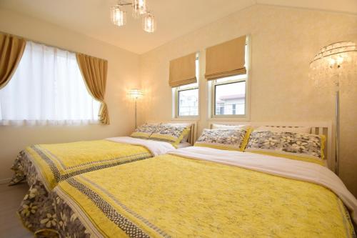 two beds in a room with two windows at Magical Dream House ★ Maihama - Vacation STAY 12402 in Tokyo