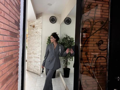 a woman in a suit walking out of a door at Terrace Tbilisi Center in Tbilisi City