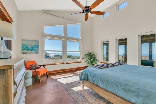 a bedroom with a bed and a ceiling fan at Dream Weaver House with Hot Tub and Ocean View! in Manchester