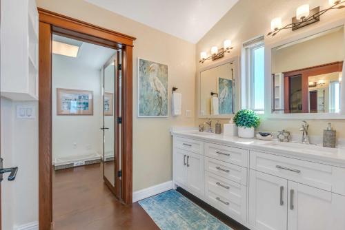 a bathroom with two sinks and a large mirror at Dream Weaver House with Hot Tub and Ocean View! in Manchester