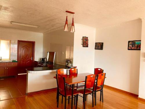 a kitchen and dining room with a table and chairs at Lavington Room1 in Nairobi