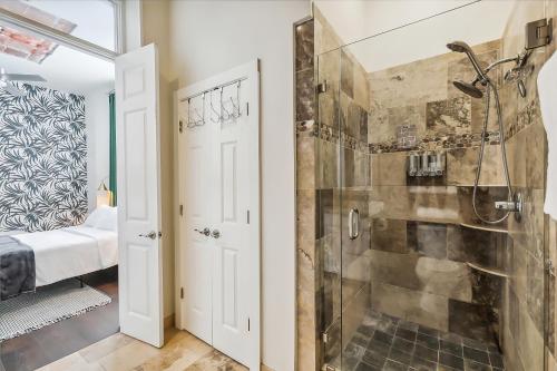 a bathroom with a shower and a walk in shower at Spacious Downtown New Orleans Vacation Rental in New Orleans