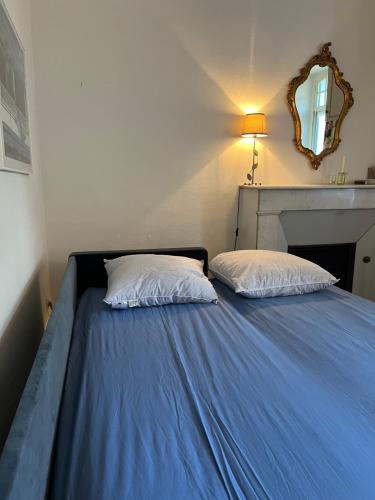 a bed with two pillows on it in a room at Enjoy Residencé Château de Monbrison, apartment for two guests in Saint-Michel