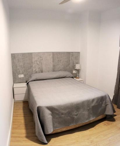 Ένα ή περισσότερα κρεβάτια σε δωμάτιο στο Apartamentos Judería Córdoba