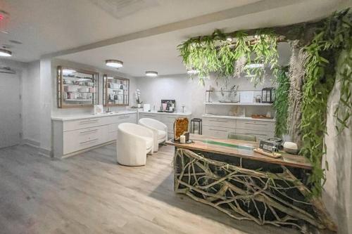 a kitchen with white cabinets and plants on the wall at Beautiful 1 Bedroom Brickell in Miami