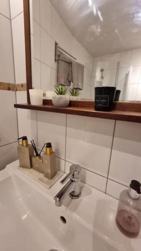 a white bathroom sink with aaucet on top of it at Central villa med extra allt. Pool, Bastu, Utekök in Kalmar