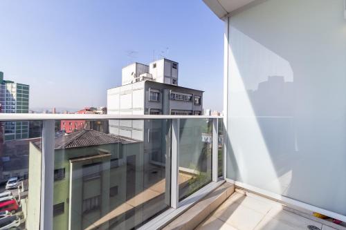 an apartment balcony with a view of a building at 360 Suítes Sé in Sao Paulo