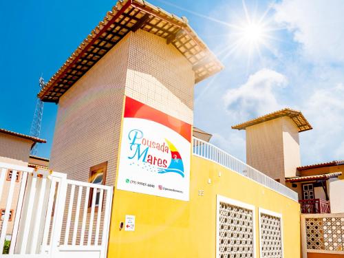 a building with a sign on the side of it at Pousada Mares em Sergipe in Estância