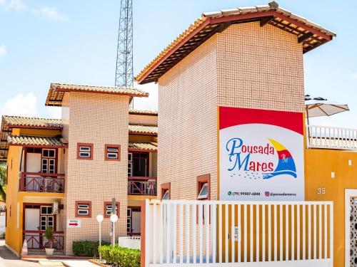 a building with a sign on the side of it at Pousada Mares Sergipe in Estância