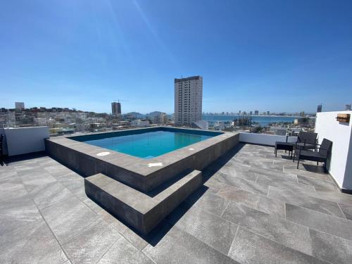 a swimming pool on the roof of a building at Condo in El Centro Near Malecon! in Mazatlán