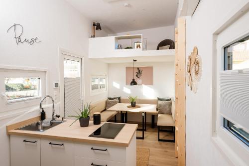 uma cozinha com um lavatório e uma sala de jantar em Tiny Om Ferienhaus em Laichingen