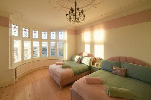 a living room with a couch and a chair at Gorwel is an Art Deco 1930s villa with sea views in Deganwy
