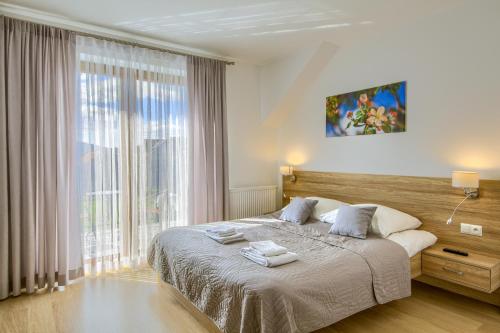een slaapkamer met een bed en een groot raam bij Willa u Alicji i Jana in Tylicz