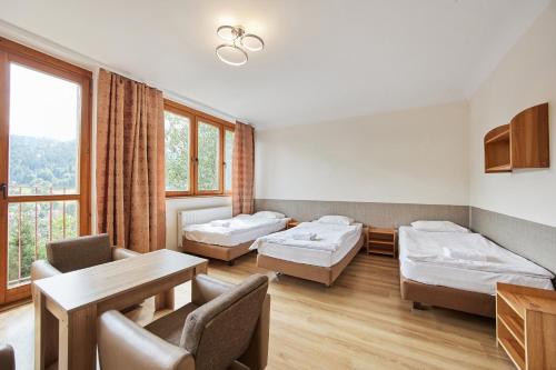 a hospital room with two beds and a table at Ośrodek Wczasowy PANORAMA Szczyrk in Szczyrk