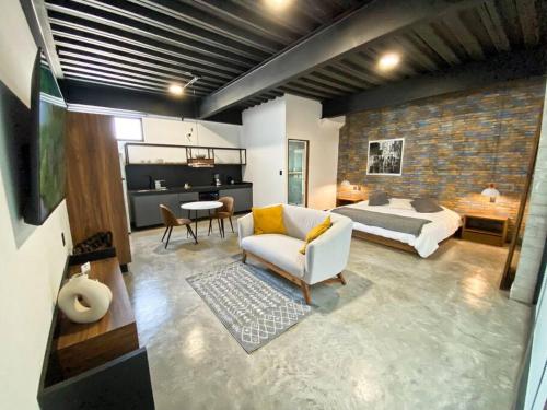 a living room with a bed and a couch and a bedroom at Loft hierro en excelente ubicación! in San Luis Potosí