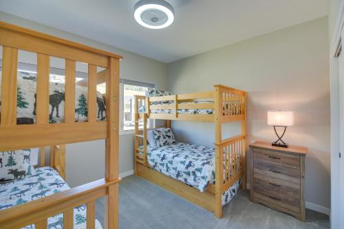 Cette chambre comprend 2 lits superposés et une table. dans l'établissement Ski-InandSki-Out Granby Townhouse with Private Hot Tub, à Granby
