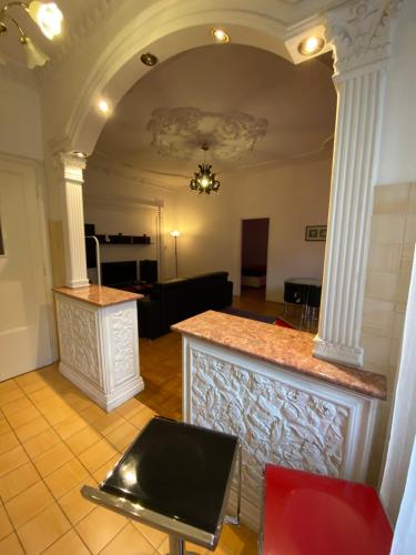 a living room with a counter and columns at HearT of the city 2 bedroms, living rooms, bathrooms, with AC in Budapest