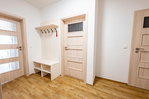 an empty room with two doors and a table at Wellness zoo apartmány Lhota in Lomnice nad Lužnicí