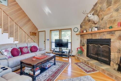 a living room with a couch and a fireplace at West Virginia Home with Deck on Golf Course in Hedgesville