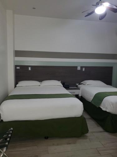 Un ou plusieurs lits dans un hébergement de l'établissement Hotel Cultura Plaza