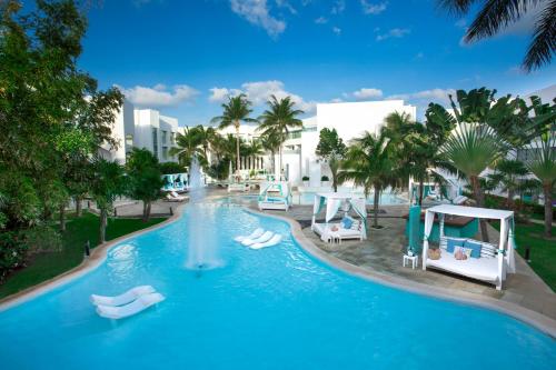 a large pool with a water slide in a resort at The Sens Tulum Riviera by Oasis in Akumal