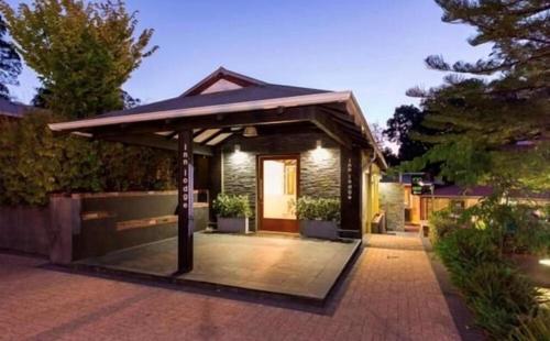 a house with a gazebo on a patio at Mahogany Inn and Distillery in Mahogany Creek